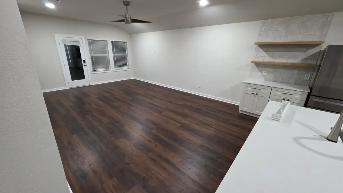 Textured luxury vinyl plank floor in a living room after a post-construction final clean by Maddox Surface in Houston